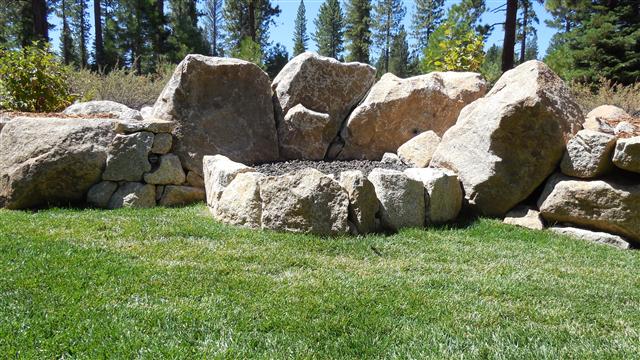 Fire pit with boulder back drop